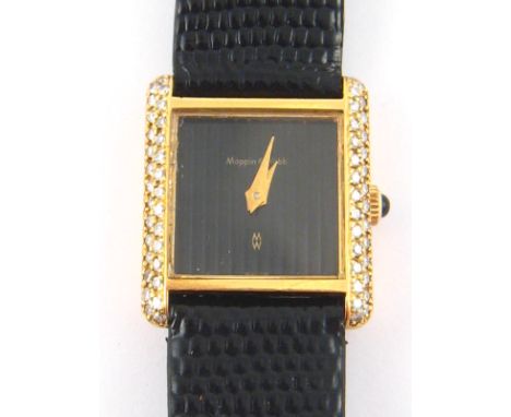 An 18ct gold and diamond lady's wristwatch with cabochon button,  the dial signed Mappin and Webb,  mechanical movement,  cas