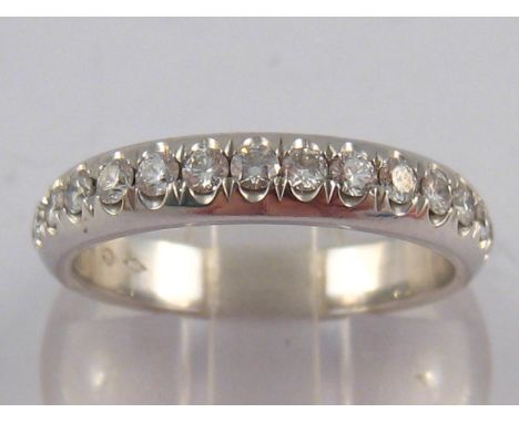 Cartier. A French hallmarked platinum diamond eternity ring by Cartier, signed Cartier and numbered DZ 8231 , approx 4mm wide