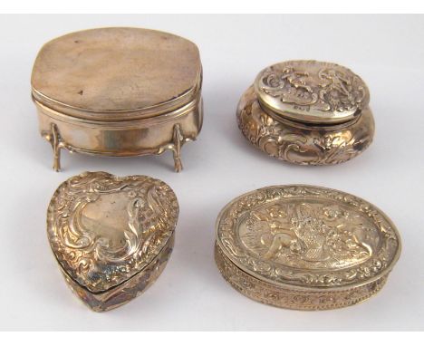 A silver trinket box on four feet, 6x5x4.5cm. high, Birmingham 1918, a heart shaped box, 5x4.5cm., Chester, 1902, a bellied o