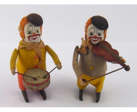 Two vintage German tinplate performing clowns, one a drummer, one a fiddler , with one key (fits both).