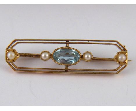 A 15 carat gold aquamarine and seed pearl bar brooch, stone approx 7.5 x 4.5mm, 3.5cm long, 3.4 gms, in fitted Goldsmiths & S