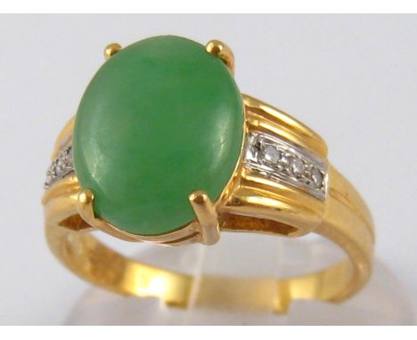 A yellow metal (tests 18 carat gold) jade and diamond ring, jade approx 11.5 x 9mm, ring size N, 5.7 gms.