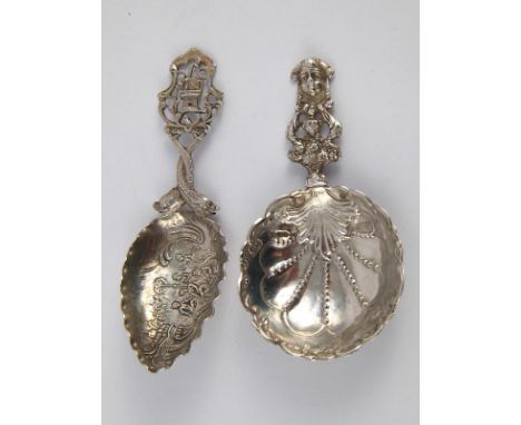 Two Dutch silver large caddy spoons, one a shell with mask finial, import marks for Chester, 1891, the other leaf shaped with