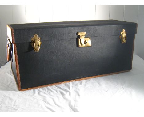 A motoring trunk, circa 1920, in treated canvas leather bound with leather carrying handles, hardwood runners and brass overc