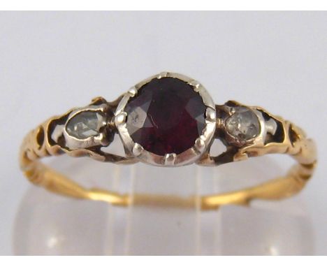 A garnet and rose cut diamond ring, with a carved yellow metal(tests 18 carat gold) shank, ring size N, 2.1 gms.
