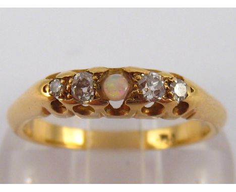 A yellow metal (tests 18 carat gold) opal and diamond ring, size L, 3.4 gms.
