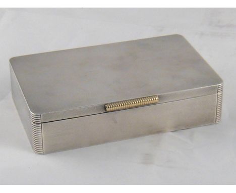 A fine silver cigarette box with engine turned finish, rounded ribbed corners and thumbpiece by Padgett and Braham, London, 1