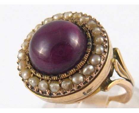 A yellow metal (tests 14 carat gold) cabochon amethyst and seed pearl ring, amethyst approx 10.5mm diameter, ring size K, 5.8