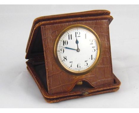 A travelling clock in fold down leather case, Swiss made, 10cm. square. 
