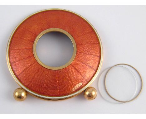 A Russian gold circular portrait frame in pink guilloche enamel on ball feet with strut back, Bears marks P.B and kokoshnik 1