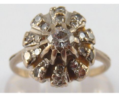 A white metal (tests 18 carat gold) diamond cluster ring, size P, 6.1 gms.
