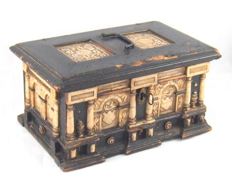 A 19th. century ebonised softwood casket in the late mediaeval manner with strap hinges, lock and key, faced with carved arch