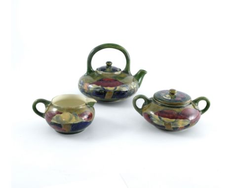 William Moorcroft, a Claremont three piece tea set, 1914, squat ovoid form with loop handles, impressed Burslem marks and dat