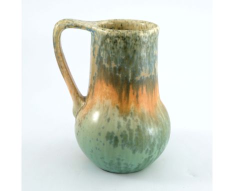 Ruskin Pottery, a Crystalline jug, 1933, bulbous gourd form with angled handle, banded blue, orange and green glazes over cre