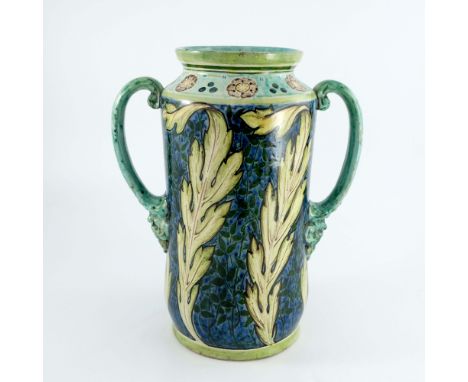 Cassandra Annie Walker for Della Robbia, an art pottery twin handled vase, 1905, cylindrical albarello form, painted with lea