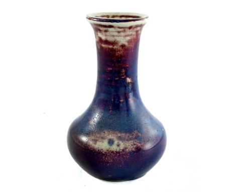 Ruskin Pottery, a High Fired vase, circa 1912, bulbous bottle form, purple and ox blood flambe glaze, impressed marks and pap