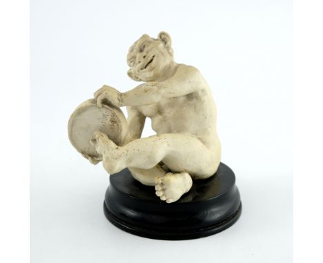 Robert Wallace Martin for Martin Brothers, a stoneware musical imp figure, 1893, modelled playing the tambourine, bisque text