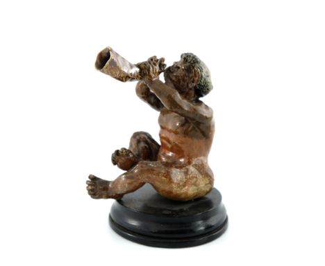 Robert Wallace Martin for Martin Brothers, a stoneware musical imp figure, 1892, modelled playing a horn trumpet, salt glazed