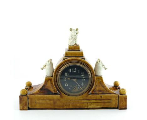 George Tinworth for Doulton Lambeth, a stoneware figural clock, circa 1875, pediment form, the 3.5 inch black dial flanked by