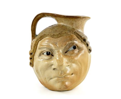 Robert Wallace Martin for Martin Brothers, a stoneware characterful Barrister face jug, 1910, modelled to each side with quiz