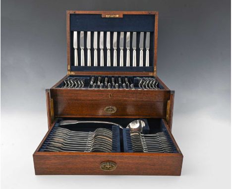 An English silver composite canteen of fiddle pattern flatware, twelve-place setting, the brass-bound fitted case, no key, wi