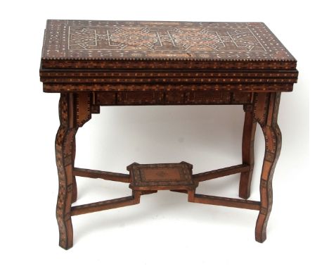 Damascus games table, circa early 20th century with good quality marquetry inlays, the folding top enclosing a fitted interio