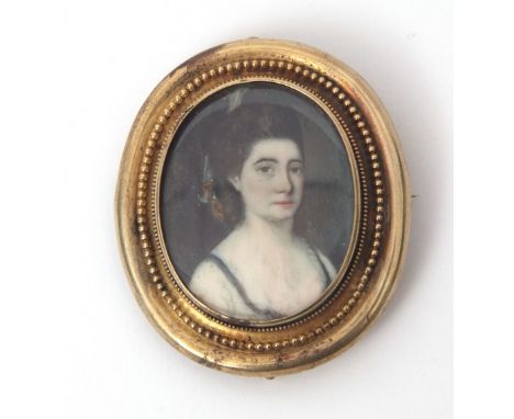 Victorian oval framed portrait brooch depicting a hand painted head and shoulders of a lady, set in a beaded decorated and pl