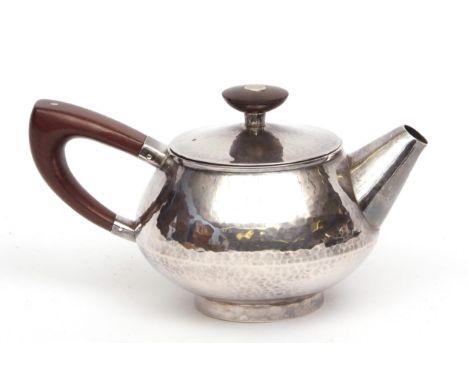 Elizabeth II bachelor's teapot, the spot hammered body with pull off cover fitted with a bladed hardwood finial and stylised 