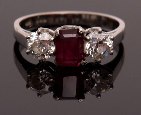 Ruby and diamond three-stone ring, the central rectangular ruby, approx 7 x 5mm, claw set between circular brilliant cut diam