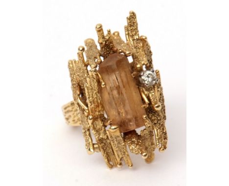 Vintage yellow metal dress ring, abstract design, the centre with a large rough cut citrine highlighted with a small diamond,