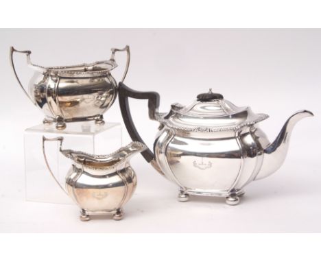 George V three-piece tea set comprising tea pot, sugar basin and milk jug, each of waisted and lobed oval form, with cast and