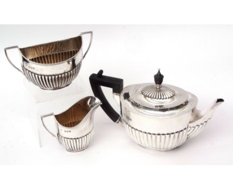 Late Victorian presentation engraved three piece tea set, each of half fluted oval form and comprising tea pot, sugar basin a