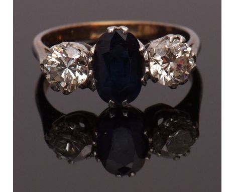 Sapphire and diamond three-stone ring, the oval shaped faceted sapphire set between two brilliant cut diamonds, 0.40ct approx