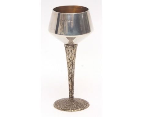 Elizabeth II silver parcel gilt goblet, the polished body with gilt lined interior to a textured and tapering stem and spread