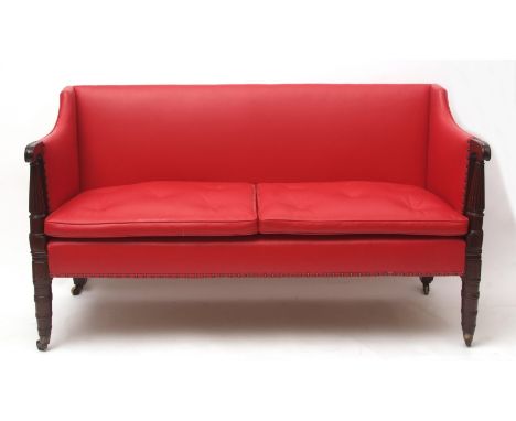 Early 19th century red leather upholstered sofa, scrolled arms raised on spreading fluted supports on ring turned front legs,