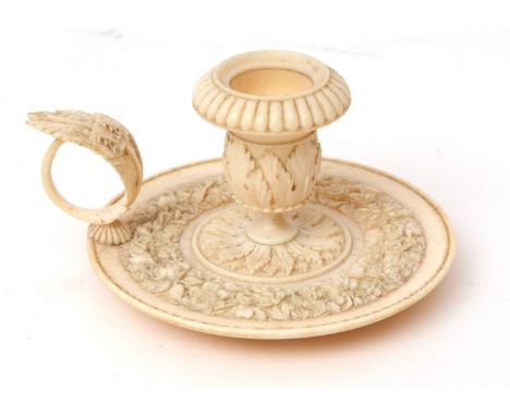 Late 19th century European carved ivory chamber stick, with urn shaped sconce with flared and fluted rim with acanthus leaf b