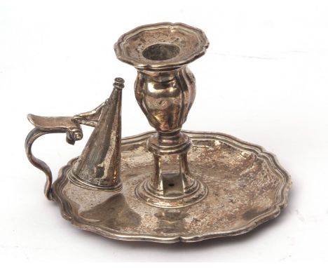 William IV chamber stick with shaped saucer base, scrolling thumb piece with central slotted and knopped column to a fixed sc