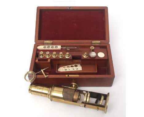 Late 19th century mahogany cased lacquered brass drum microscope of typical form with screw adjusting tube over a pierced cir