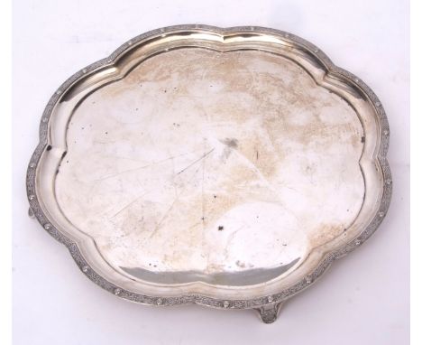 George VI silver tray of lobed circular form with cast and applied Celtic border to a plain field and raised on four cast and