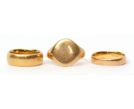 Group of three rings: 18ct gold plain polished signet ring, 7.1gms, together with two 22ct gold wedding rings, 12.7gms (3)  