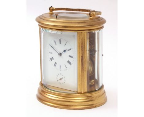 Late 19th century French gilt and lacquered brass oval carriage alarm clock, with push repeat, 794, the large silvered lever 