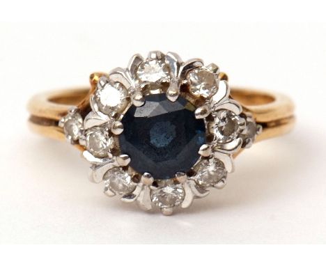 Sapphire and diamond cluster ring, the circular shaped sapphire within a surround of eight small diamonds, having diamond hig