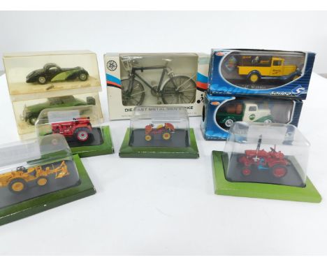 Five Hachette die cast models of collectable tractors, in blister packs, together with a die cast metal men's bike, scale 1:1