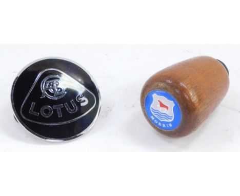 A Lotus metal and black enamel car badge, together with a Morris gear stick knob.  (2)