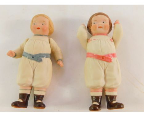Two bisque porcelain figures of children, modeled with articulated arms, one with pink sash and detailing, the other with blu