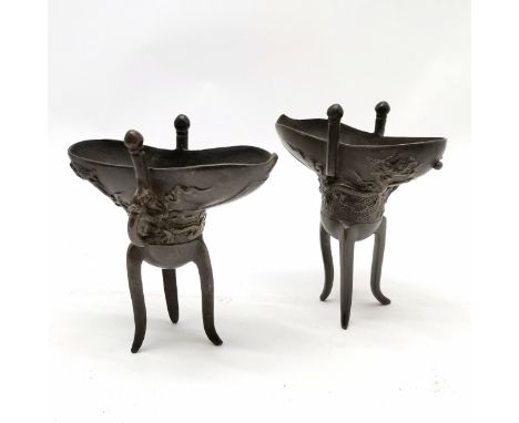 pair of Antique Chinese bronze Jue libation/wine vessels with dragon chasing flaming detail to body and on 3 high style legs 