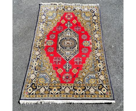Large blue and yellow grounded rug  with bird detail and red central medallion 225cn x 140cm