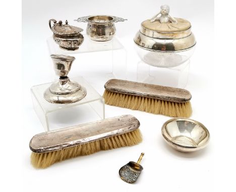 Quantity of silver including lidded mustard, tea strainer on stand, pair brushes lidded vanity pot with china doll finial etc