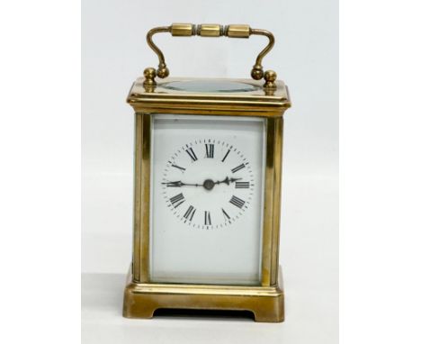 An Early 20th Century brass carriage clock with bevelled glass panels. Circa 1900. 8x7x12cm