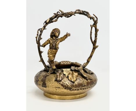A large 19th Century, French bronze and gilt spelter sculpture/basket, with playing boy on a branch style handle. 24x24x32cm